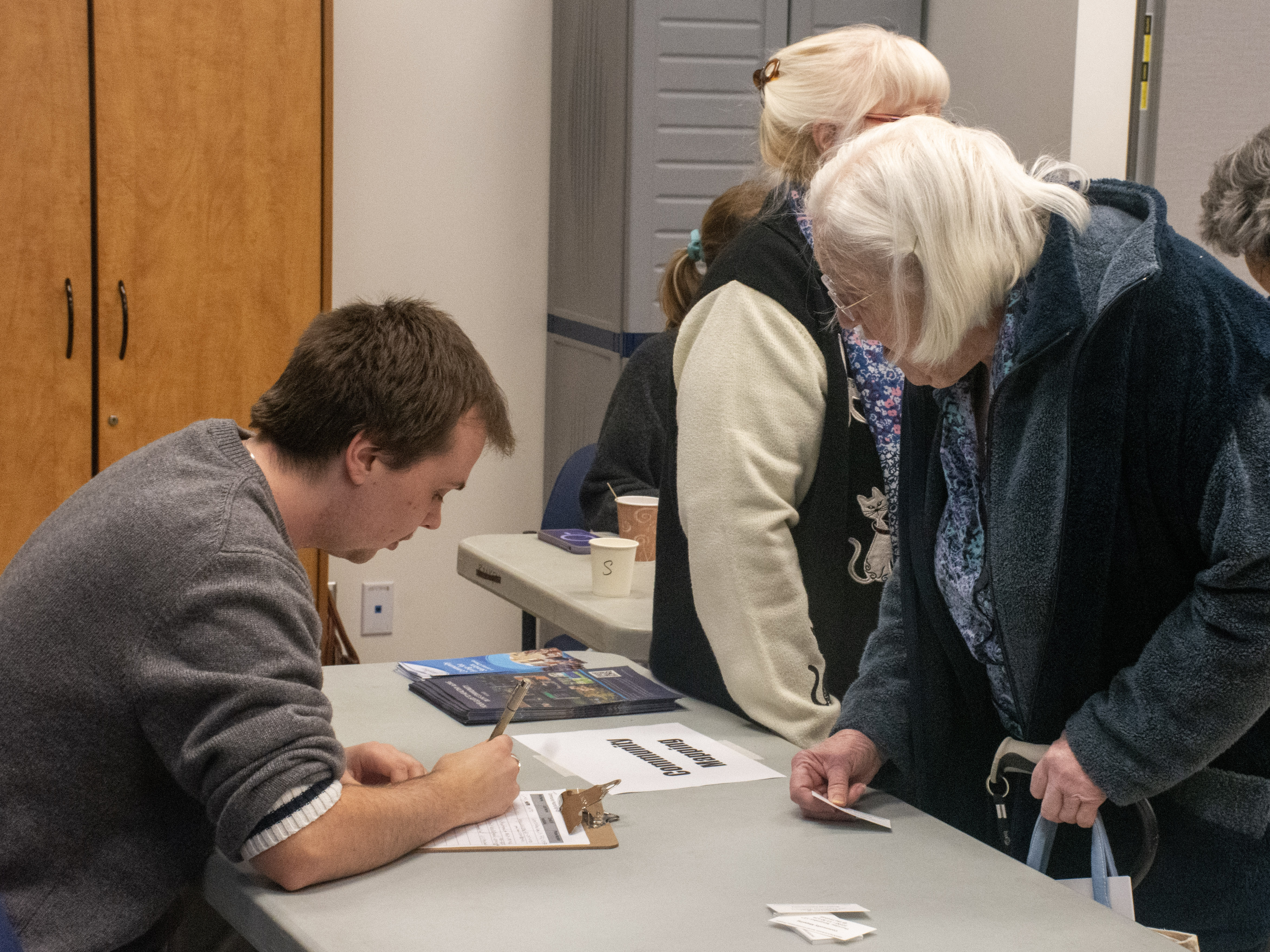 Student taking registration information from a senior